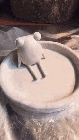 GIF of someone creating a frog/lily pad trinket dish and then painting it