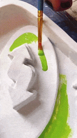 GIF of someone adding final touches trinket dishes designed to look like Uno cards